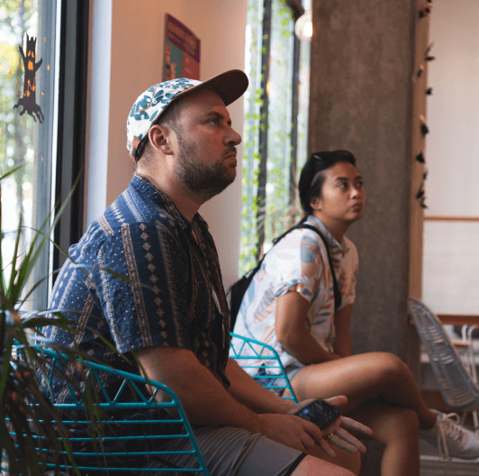 By the Pixel employees seated in decorative turquoise chairs in a lobby.